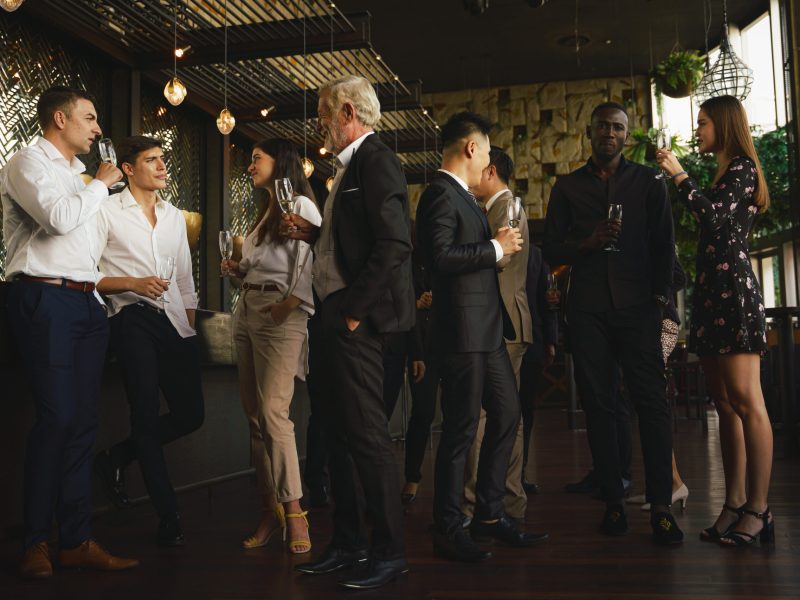 corporate businesspeople having fun and talking together in corporate party in club to celebrate spacial event such as corporate aniversary